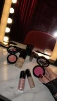 Blush compacts on a marble vanity